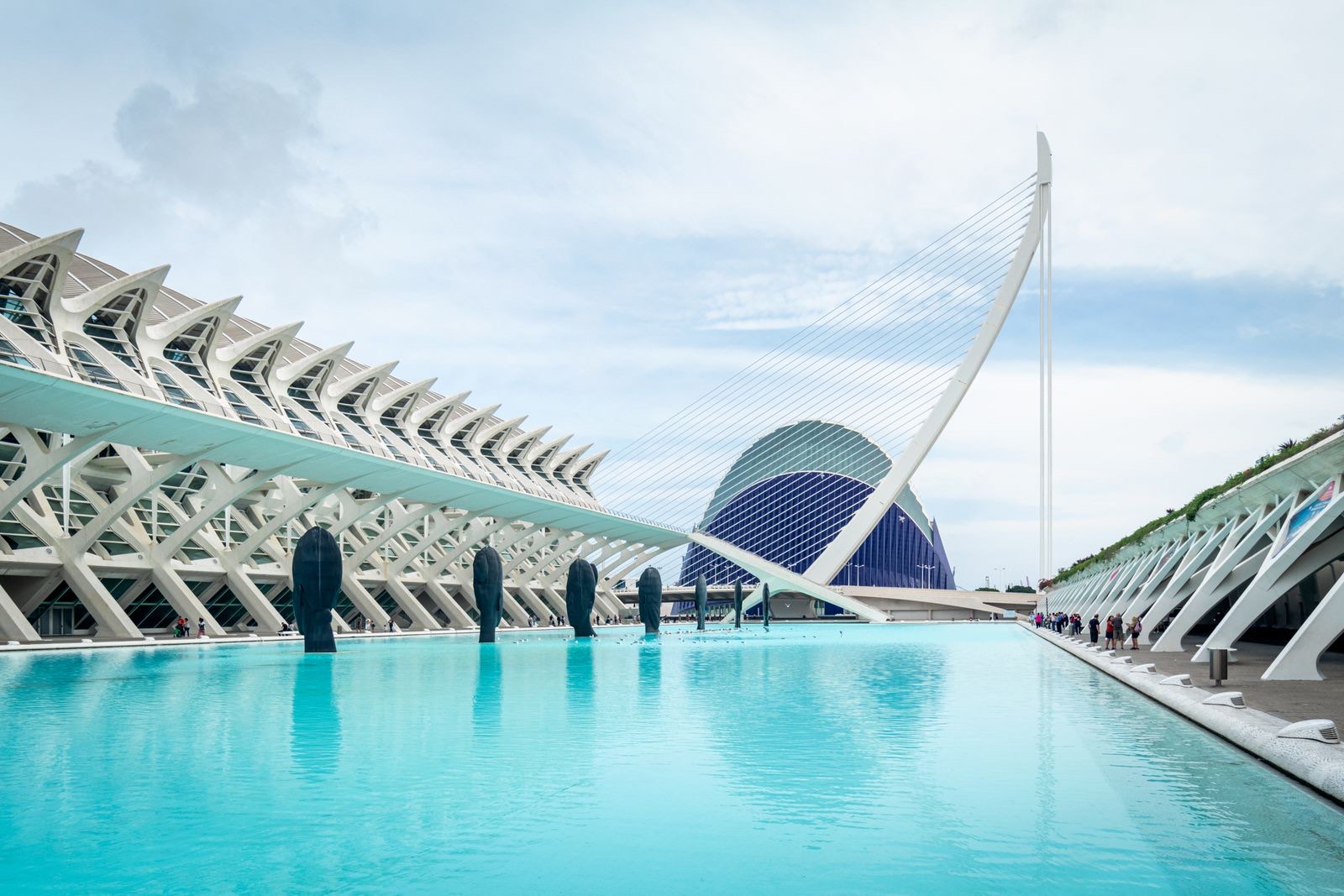 The white ribbed science museum, a cable bridge and the blue Agora beside a long turquoise pool at the City of Arts and Sciences in Valencia, Spain, the starting point for a move to Dubai